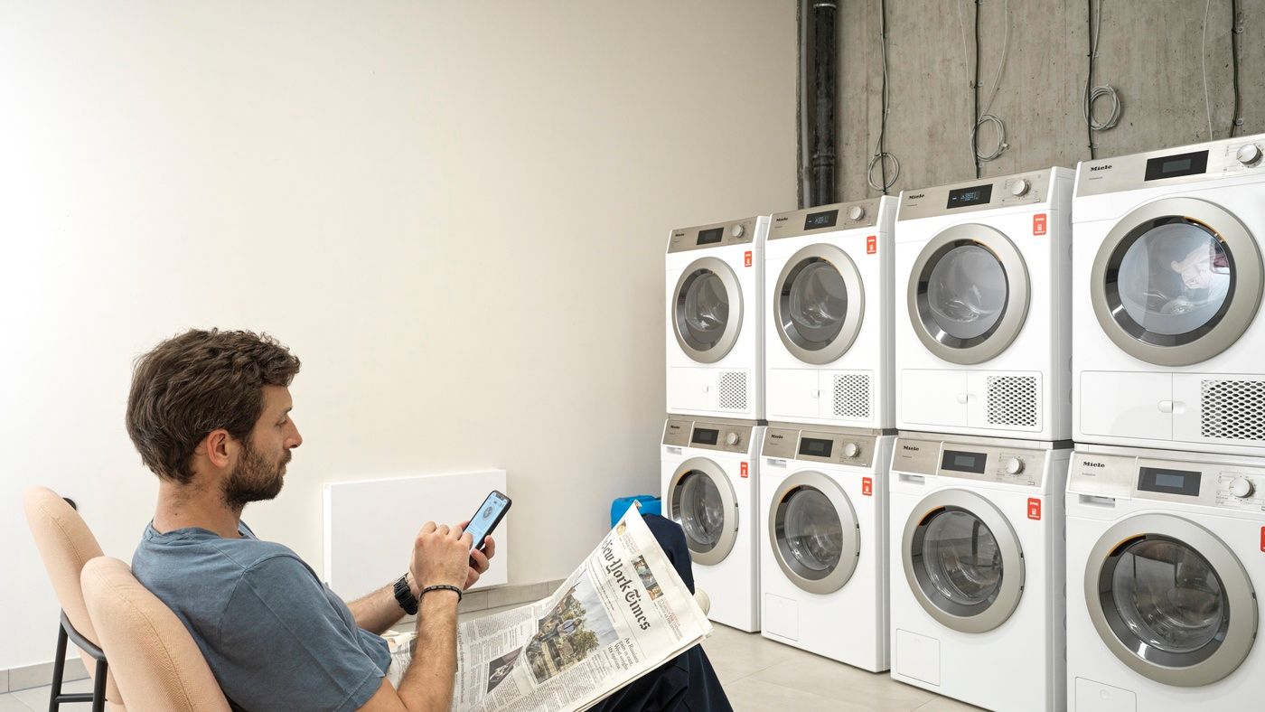 Man sitting in self-service laundry