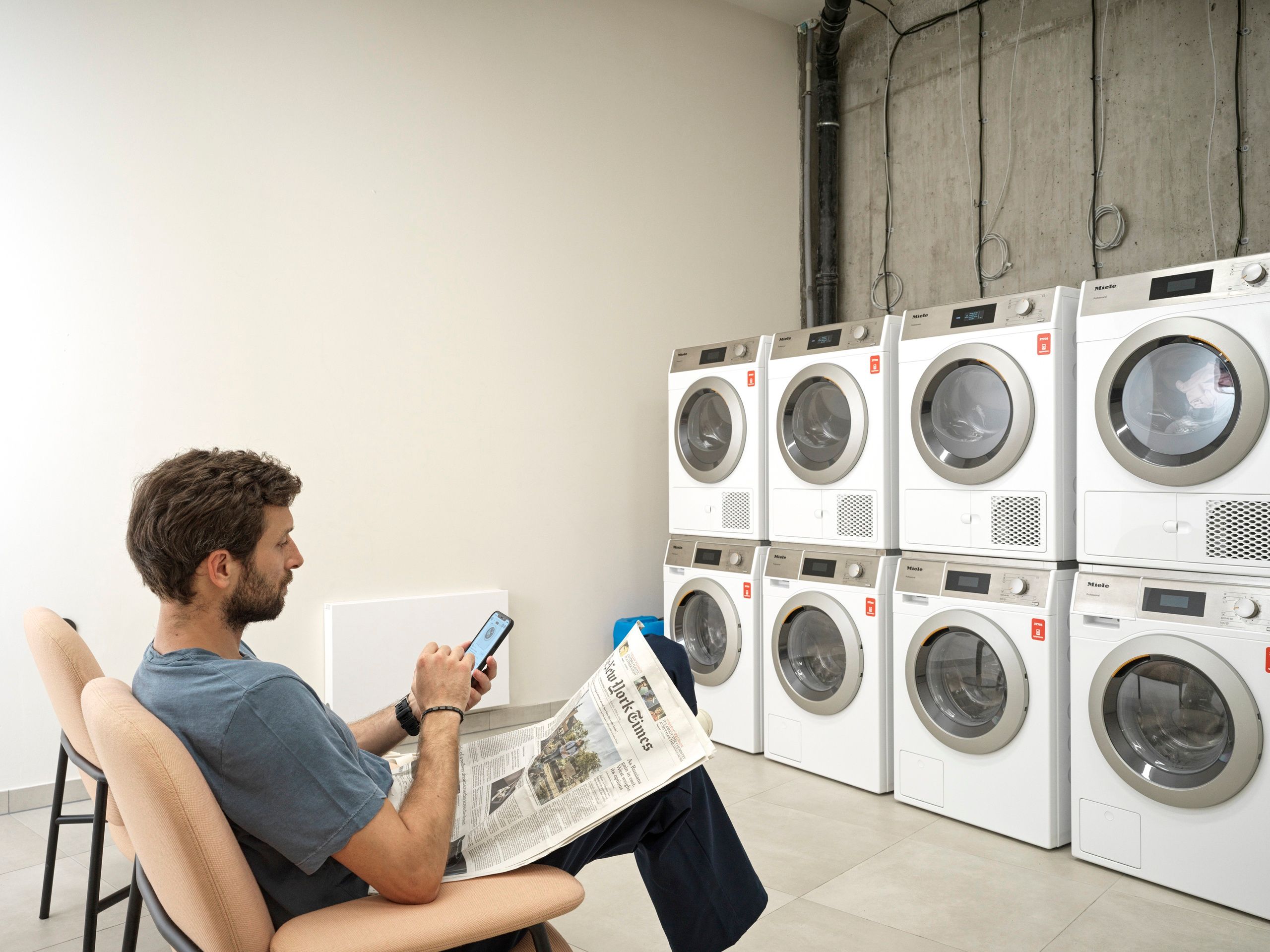 Man sitting in self-service laundry 