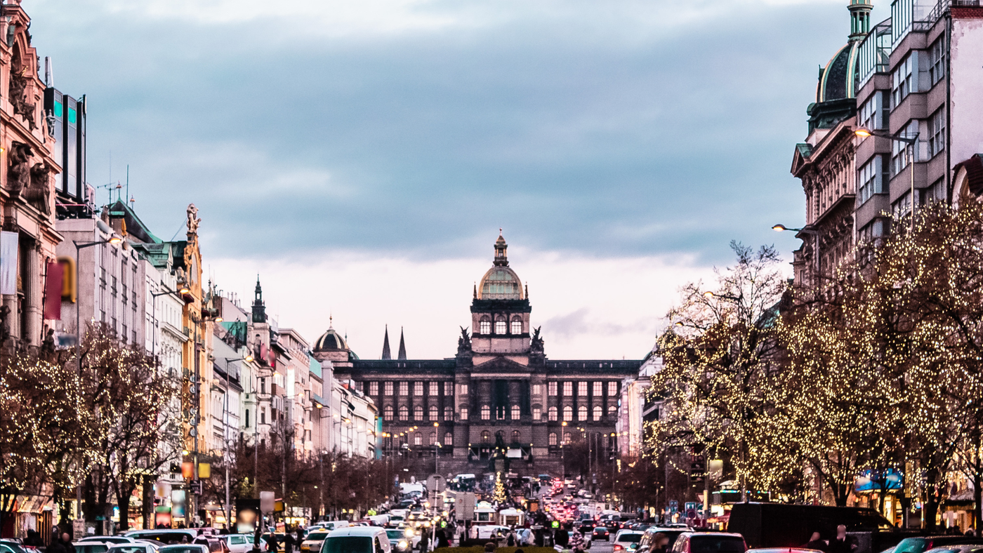 Wenceslas Square in Pristine Serenity: A captivating view of Wenceslas Square under a cloudy yet picturesque sky. The vivid, cool colors of the scene complement the architectural elegance, featuring the imposing National Museum. This image captures the square's unique charm and historical significance in a moment of quiet beauty.
