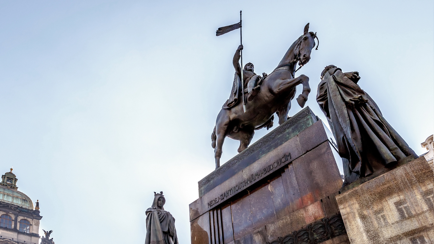 Statue on Wenceslas Square under Cloudy Skies: The iconic statue at Wenceslas Square stands tall against a backdrop of overcast skies, creating a dramatic and contemplative scene. The statue's details and historical significance are emphasized by the diffused lighting.