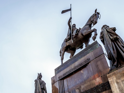  Statue on Wenceslas Square under Cloudy Skies: The iconic statue at Wenceslas Square stands tall against a backdrop of overcast skies, creating a dramatic and contemplative scene. The statue's details and historical significance are emphasized by the diffused lighting.