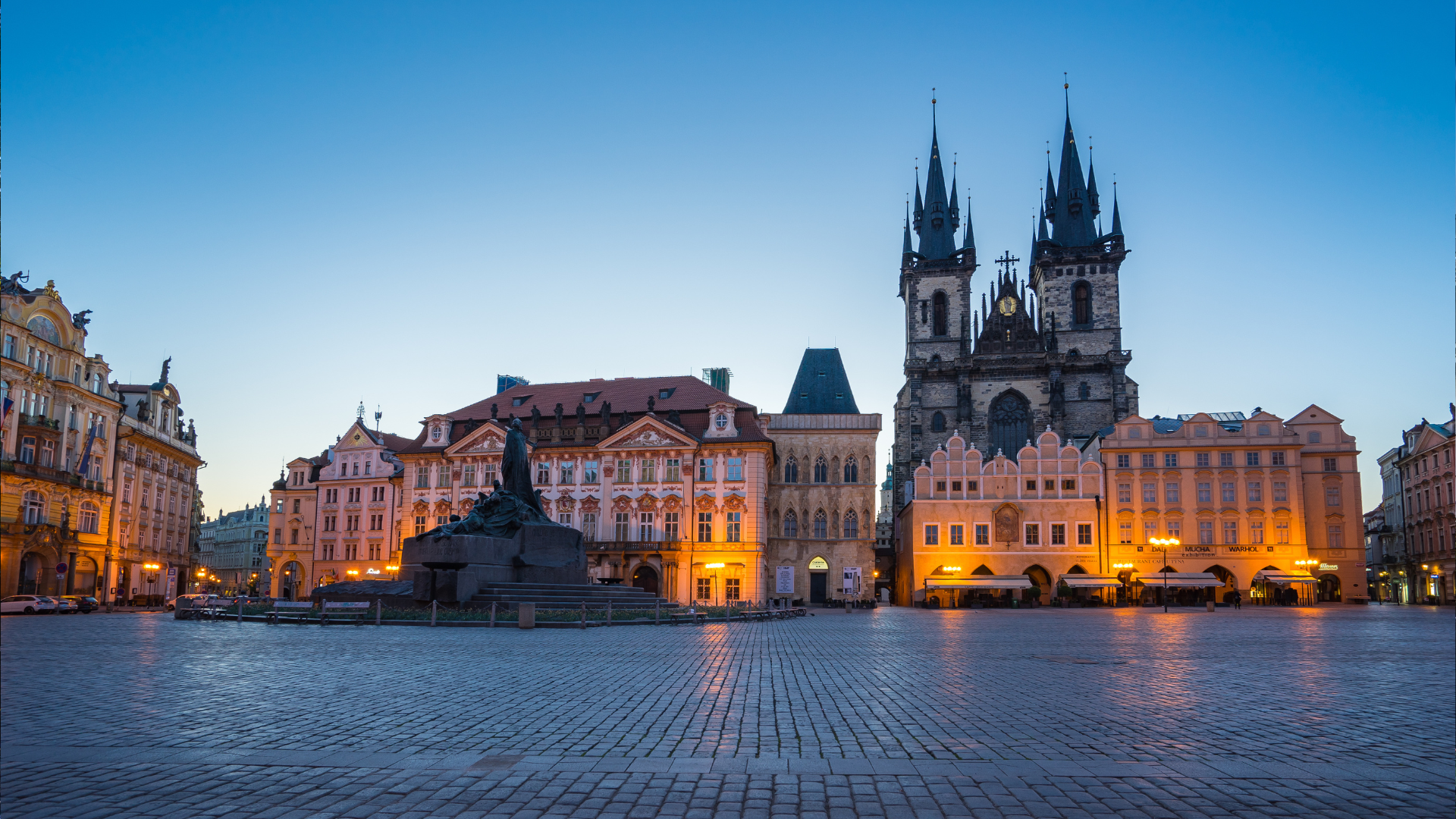 Vivid Sunset at Old Town Square: Enjoy a captivating moment at Prague's Old Town Square as the sun sets in a blaze of oranges and pinks. The square, bathed in the warm, golden hues of dusk, offers a serene and timeless view. With its iconic architecture and historic charm, Old Town Square stands as a testament to the city's rich heritage. This image captures the essence of Prague's beauty, inviting you to explore its historic heart. 